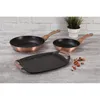 A set of three granite-coated cookware items, including two frying pans and a griddle pan, are displayed on a wooden surface in front of a brick wall. Podgląd zdjęcia produktu