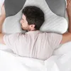 A man is sleeping on a pillow in a bed. Náhled obrázku produktu
