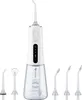 A white water flosser with multiple attachments is displayed against a white background. Produktbild-Vorschau