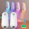 Two white motion-activated LED night lights are shown in the foreground, with four similar lights mounted on a wall in the background, emitting colorful light. Náhled obrázku produktu