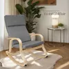 A rocking chair in a living room setting with a plant and a side table with a lamp. Náhled obrázku produktu