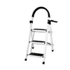 A white stepladder with black anti-slip treads and a black padded handle is shown against a white background. Voir les images du produit