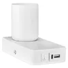 A white lamp with a cylindrical shade sits on a white rectangular base. The base has a switch and USB ports. Podgląd zdjęcia produktu