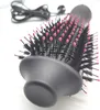 A close-up shot of a black and pink hair dryer brush. Podgląd zdjęcia produktu