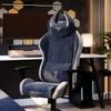 A gaming chair is set up in a modern office or gaming room, next to a desk with a computer monitor. Produktbild-Vorschau