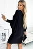 A woman is posing in a black dress. Anteprima dell’immagine prodotto