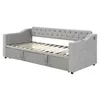 A gray upholstered daybed with a pull-out trundle bed is shown from a side angle against a white background. Produktbild-Vorschau