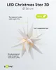 A white LED Christmas star with informational text and a logo. Produktbild-Vorschau