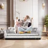 A woman is hugging a dog on a sofa in a living room. Náhled obrázku produktu