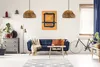 A living room scene with a sofa, coffee table, artwork, and a bicycle. Produktbild-Vorschau