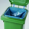 Close-up of a green trash can with a blue trash bag inside, and the lid is open. Náhled obrázku produktu
