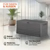 A grey storage box with a wood-like texture is placed in a modern, well-lit indoor space with large windows and plants. Produktbild-Vorschau