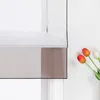 A close-up of a window blind with tulips in the foreground. Produktbild-Vorschau