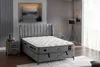 A bedroom scene featuring a bed with a mattress, a nightstand, and a floor lamp. Produktbild-Vorschau