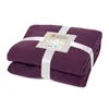 A folded purple fleece blanket with a label attached by white ribbons. Produktbild-Vorschau