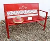 A red metal garden bench with a straw hat and a book on it, placed on a gravel surface. Produktbild-Vorschau