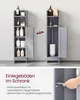 Two grey bathroom cabinets are shown side-by-side, with one open to reveal a toilet brush holder and the other displaying various bottles and containers on its shelves. Below, text describes adjustable shelves. Podgląd zdjęcia produktu