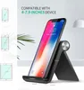 A black phone stand holding a smartphone, with diagrams of compatible devices on the left. Voir les images du produit