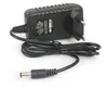 A black power adapter with a European plug and a coiled cable with a DC barrel connector. Anteprima dell’immagine prodotto