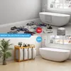 A split image showing a messy bathroom floor with clothes scattered around in the top panel, and a tidy bathroom with a laundry basket in the bottom panel. Anteprima dell’immagine prodotto