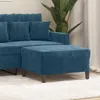 A close-up shot of a blue velvet ottoman in front of a sofa. Náhľad obrázku produktu