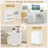 Collage showing a white folding sewing table in expanded and folded states, and a white cabinet on wheels. Anteprima dell’immagine prodotto