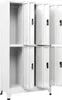 A white metal locker cabinet with multiple compartments, some open and some closed. Anteprima dell’immagine prodotto