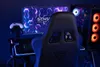 A gaming setup with a chair, computer, and monitor. Produktbild-Vorschau