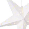 A close-up of a white paper star lantern with cut-out star shapes illuminated from within. Náhled obrázku produktu