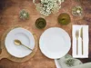 A table setting with plates, cutlery, glasses, and flowers. Náhľad obrázku produktu