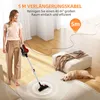 A woman is vacuuming a room with a cordless vacuum cleaner, while a dog rests on the rug. Voir les images du produit