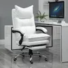 A white ergonomic office chair with a footrest is shown in a modern office setting next to a desk with a computer. Produktbild-Vorschau
