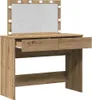 A makeup vanity table with a mirror and lights. Voir les images du produit