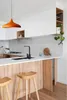 A modern kitchen island with a pendant light, sink, faucet, and stools. Produktbild-Vorschau