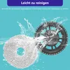 Two parts of a robot vacuum cleaner's mopping system are shown, one a white mopping pad and the other a black holder, with water splashes around them against a light blue background. Produktbild-Vorschau