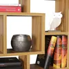 A close-up of a bookshelf with books and decorative items. Produktbild-Vorschau