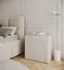 A bedroom scene with a bed, nightstand, and floor lamp. Produktbild-Vorschau