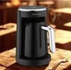 A black coffee maker on a wooden table with steam rising. Produktbild-Vorschau