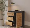 A modern sideboard with drawers and a door, placed in a room with a plant and a lamp. Produktbild-Vorschau
