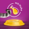 A cat's tail is shown next to a yellow food bowl, with a graphic of a chicken leg and text indicating "mit Huhn" (with chicken) in the background. Náhľad obrázku produktu