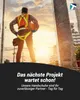 A construction worker stands looking out at a sunset over a city skyline. Produktbild-Vorschau