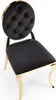 A studio shot of a black and gold chair. Podgląd zdjęcia produktu