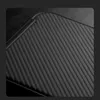 A close-up view of a black textured surface with parallel ridges. Voir les images du produit