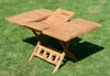 A wooden folding table with extendable leaves sits on a grassy lawn. Produktbild-Vorschau
