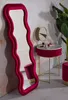 A stylish vanity area with a large wavy mirror, a round vanity table, and a stool. Podgląd zdjęcia produktu