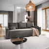 A modern living room with a gray sofa, coffee table, and decorative elements. Produktbild-Vorschau