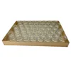 A tray of small glass jars. Voir les images du produit