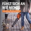 A person is using a leaf blower to clear leaves from a wooden deck. Podgląd zdjęcia produktu