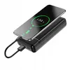 A black power bank with a smartphone charging on top, showing a 54% charge indicator on the phone screen. Produktbild-Vorschau