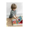 A young boy is playing with a monster-themed toy on a wooden table. Podgląd zdjęcia produktu